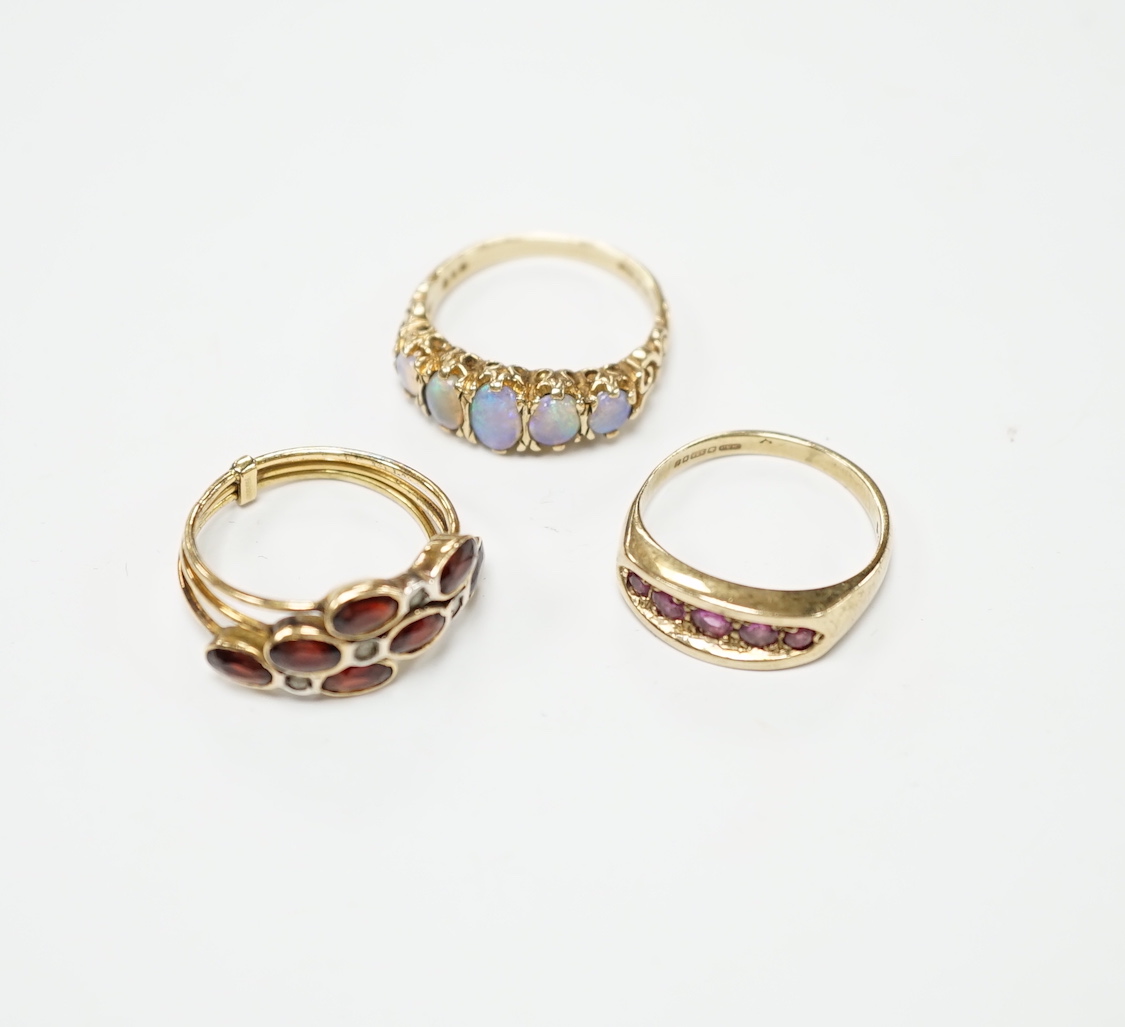 Two recent 9ct gold and gem set rings, including graduated five stone opal half hoop ring, together with a continental and gem set triple shank ring, gross weight 10.5 gram.